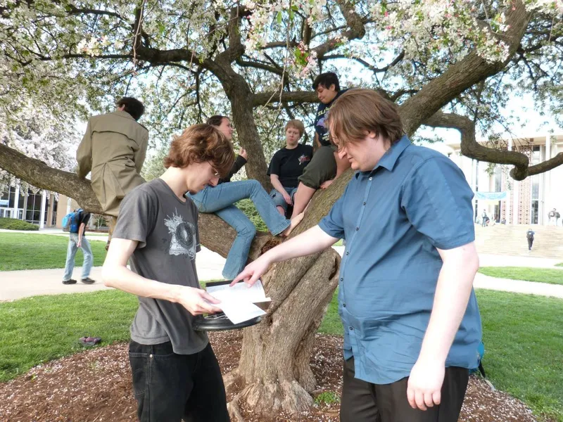 Computer Science Faculty Member at right pointing out something in a text.